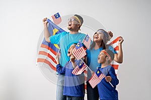 Malaysian family holding malaysia flag over white background