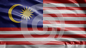 Malaysian flag waving in the wind. Close up of Malaysia banner blowing soft silk