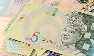 Malaysian Ringgit banknote on another Southeast-asian currency