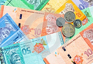 Malaysian ringgit banknotes and coins background.