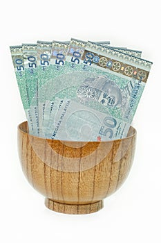 Malaysian Ringgit in a Wooden Bowl photo