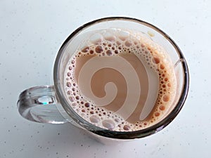 Malaysian signature drink called `TEH TARIK`. Tea drinks mixed with creamy white creamers.