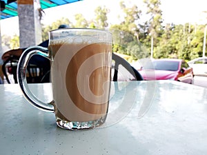 Malaysian signature drink called `TEH TARIK`. Tea drinks mixed with creamy white creamers.