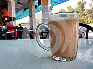 Malaysian signature drink called `TEH TARIK`. Tea drinks mixed with creamy white creamers.