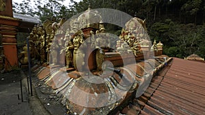 Malaysian temple with golden statues of the saints. Action. Concept of religion and culture.