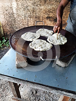 Malaysians& x27; favorite food, roti canai, is being cooked on a special pan