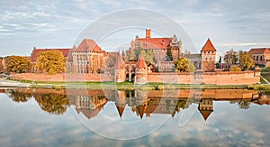 Malbork castle autumn panorama with reflection