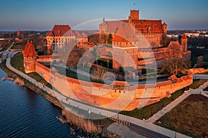 Malbork castle over the Nogat river at sunset, Poland photo