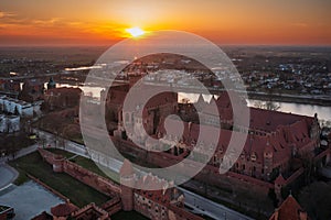 Malbork castle over the Nogat river at sunset, Poland photo