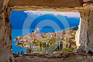 Malcesine and Lago di Garda aerial view through stone window photo