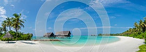 Maldives beach panorama view with blue ocean and sky near villas