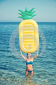 Maldives or Miami beach water. Girl sunbathing on beach with air mattress. Sexy woman on Caribbean sea in Bahamas