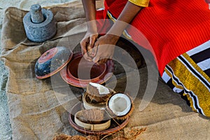 Maldivian girl cooking breakfast from coconuts