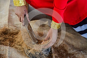 Maldivian girl working with crude for ropes