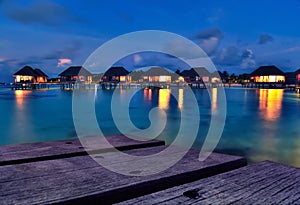 Maldivian water bungalows at dusk