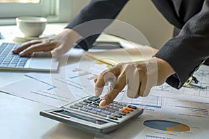 Male accountants are working on financial documents and calculators for business.