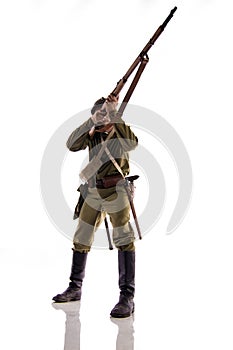 Male actor in the form of an ordinary soldier of the Russian army during the First World War posing against a white background in