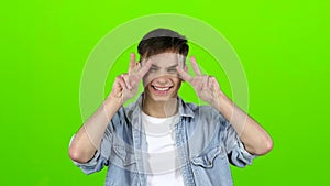 Male actor smiles, showing them different grimaces and language. Green screen. Slow motion