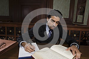 Male Advocate Reading Law Book