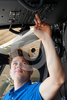 Male Aero Engineer Working In Helicopter Cockpit