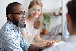 Male african-american talking to coworkers timeout in office