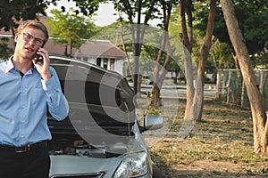 male agent use smart phone for claiming auto insurance. caucasian man calling for assistance for car broken down by traffic