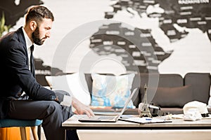 Male agent working at the travel agency office