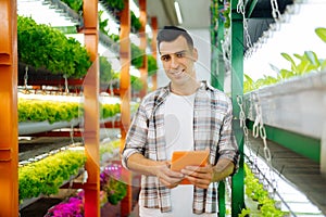 Male agriculturist smiling while starting successful project