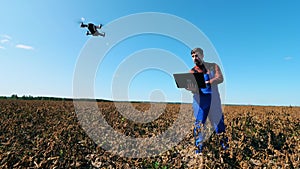 Male agronomist is navigating a drone from the computer