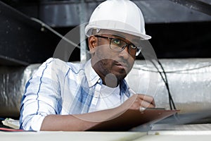 Male air conditioning repairman with clipboard