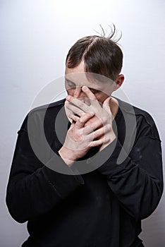 Male alcoholic and drug addict of a sickly appearance on a white background