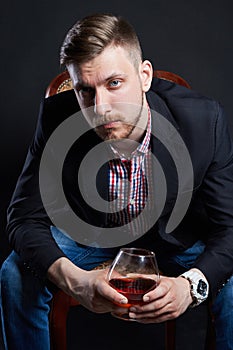 Male alcoholism, man with a glass of alcohol in hand. Disease of alcoholic addiction, bad habit, stress relief through alcohol