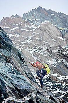 Male alpinist climbing mountain in Austria.