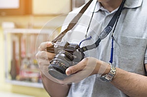 Male amateur photographer taking focusing to make photos in cont