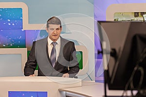 Male anchorman in tv studio. Live broadcasting