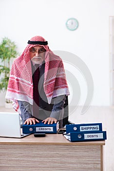 Male arab bookkeeper extremely tired with an excessive work