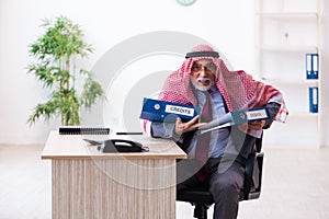 Male arab bookkeeper extremely tired with an excessive work