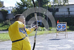 Male archer aiming at a mark on an archery shooting range