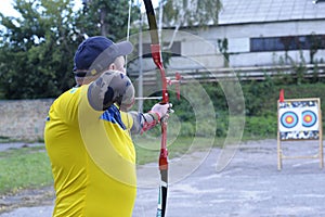Male archer aiming at a mark on an archery shooting range