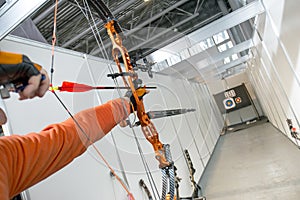 Male archer shooting in competitions of the compound bow with arrows