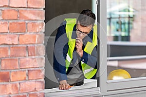 male architect with blueprint working at office