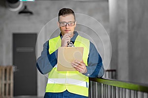 male architect with clipboard at office
