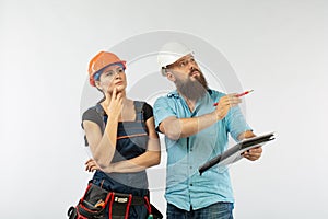 A male architect or engineer meeting with a building woman contractor on white background