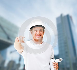 Male architect in helmet pointing at you