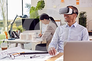 Male Architect In Office Using VR Headset To Design New Building