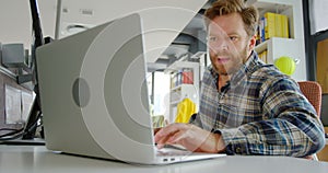 Male architect using laptop at desk 4k