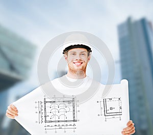 Male architect in white helmet with blueprint