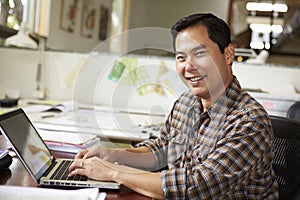 Male Architect Working At Desk On Laptop