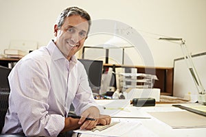 Male Architect Working At Desk In Office