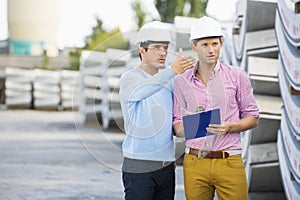 Male architects inspecting inventory at site